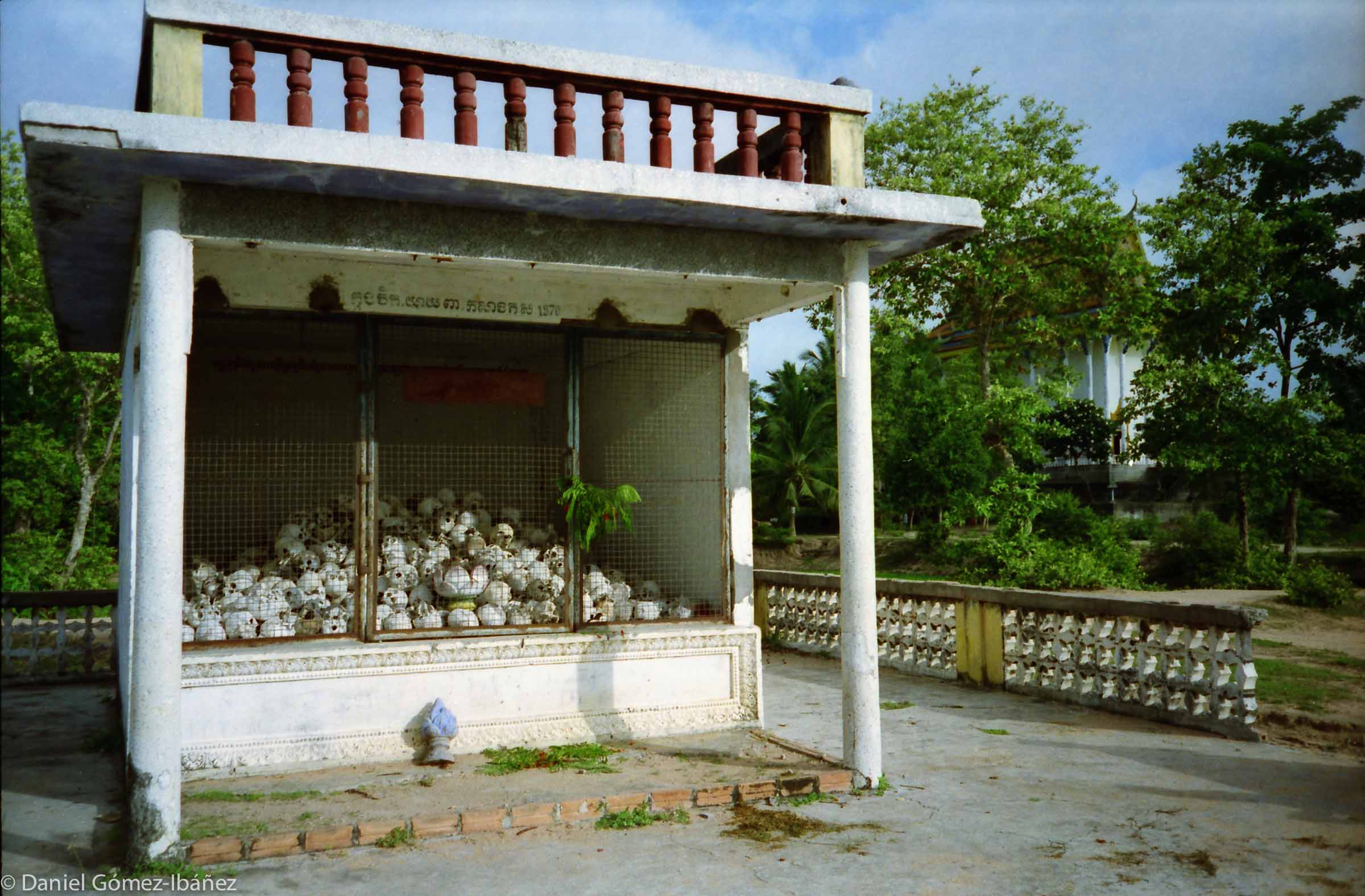 During the Pol Pot years (1975-9) many Buddhist temples became prisons and execution places. An estimated two million Cambodians died: 25% of the population. Educated persons, landowners, monks, and professionals were particularly targeted. This shrine  stands beside a restored pagoda. ©1996