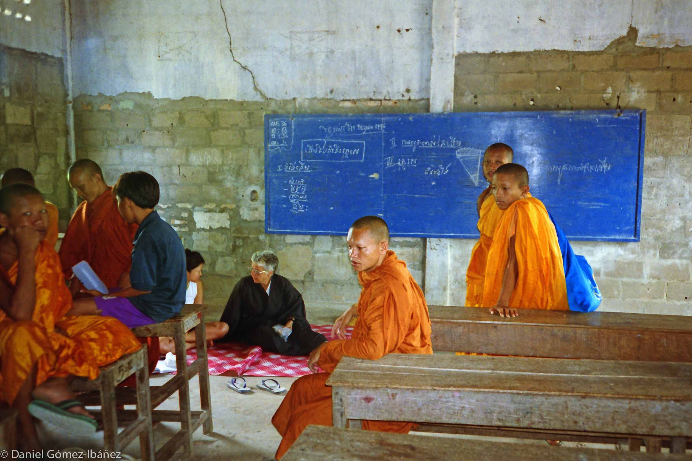 The peace walk stopped to rest at a rural school. These young monks -- too young to remember the holocaust of the 1970s -- noticed the bullet holes in the walls. The school had been a place of executions.