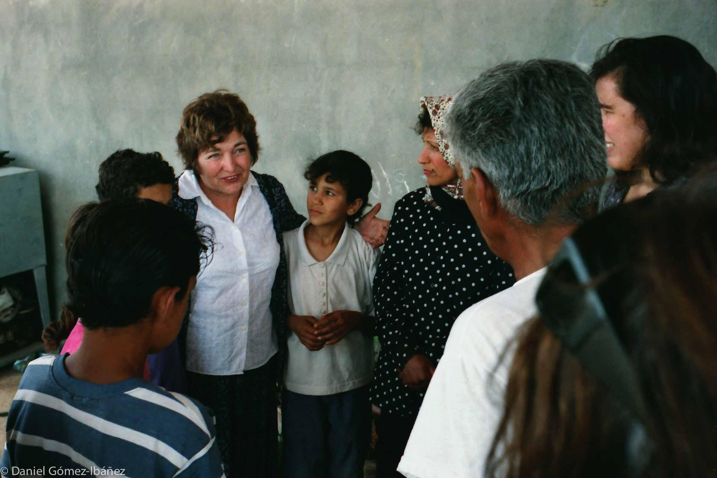 In a Palestinian town on the West Bank, Mairead Maguire (Nobel Peace Prize, 1976) talks with a family whose home was threatened with demolition by Israeli authorities. [Israel/Palestine, 2000]