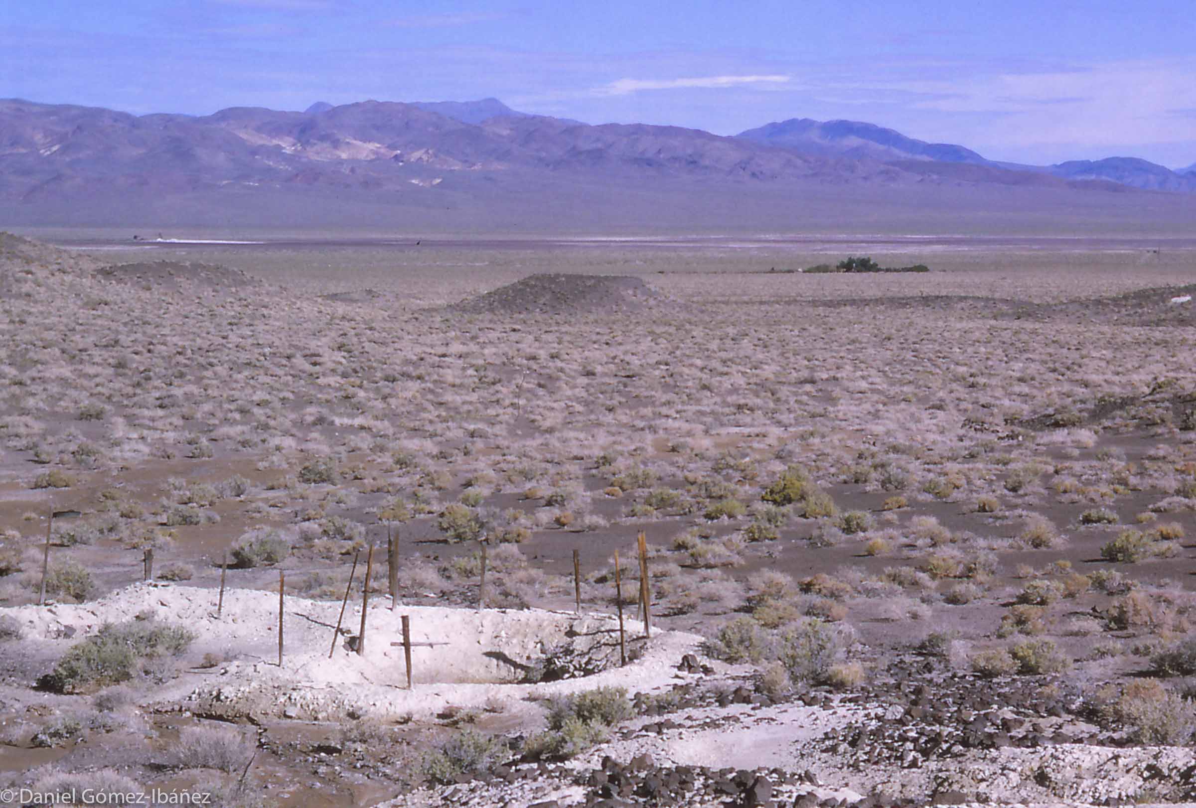 A water hole in an arid basin of Nevada. It's too dry and hot in summer, but there's adequate forage in winter when snow closes the mountains. Flocks are moved weekly to prevent overgrazing.