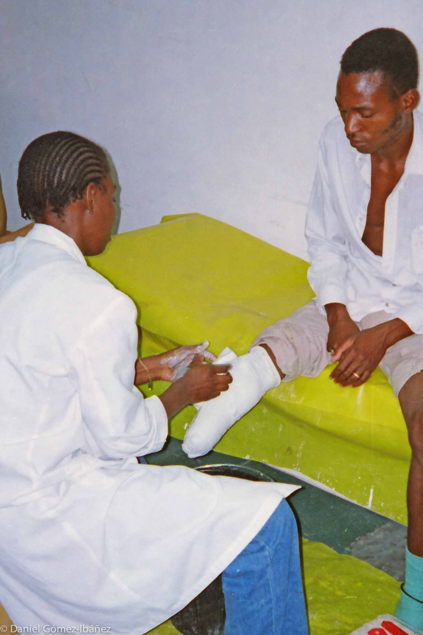 Thirty years of civil war in Mozambique ended in 1992 but left more than 10,000 landmine casualties. Throughout the country -- one of Africa's poorest -- victims had almost no access to medical services. In the 1990s only Maputo's Central Hospital could provide orthopedic rehabilitation. Here a technician makes a plaster mold of the stump, the first step in fashioning a prosthetic leg. © 1997